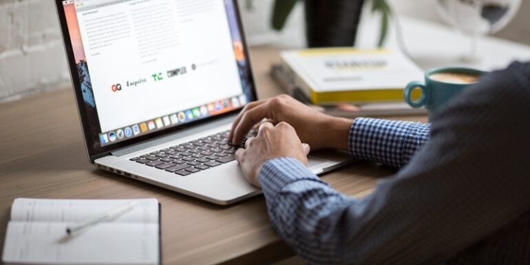 A person typing on a laptop.